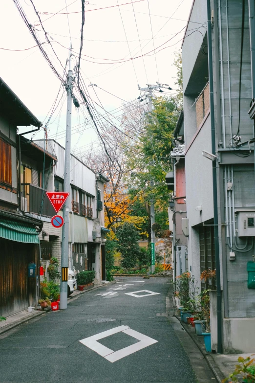 a red stop sign on a narrow street