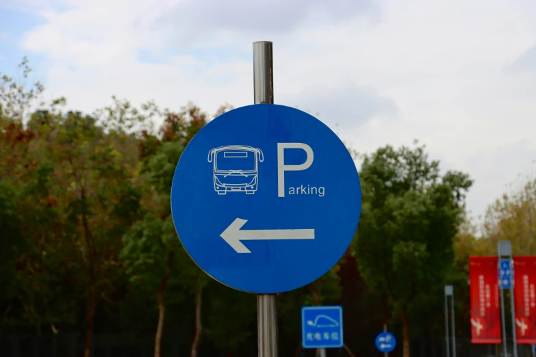 a blue sign points to a bus stop where you can go