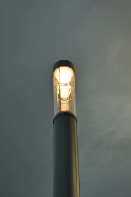 a street light sitting under a cloudy sky