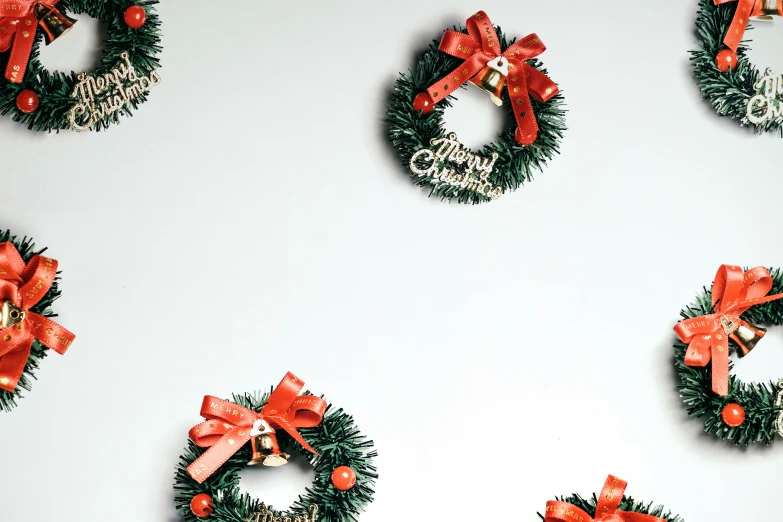 an array of christmas wreaths with bows on them