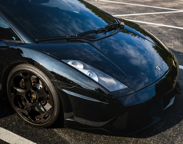 a black lambach is parked on the road in a parking lot