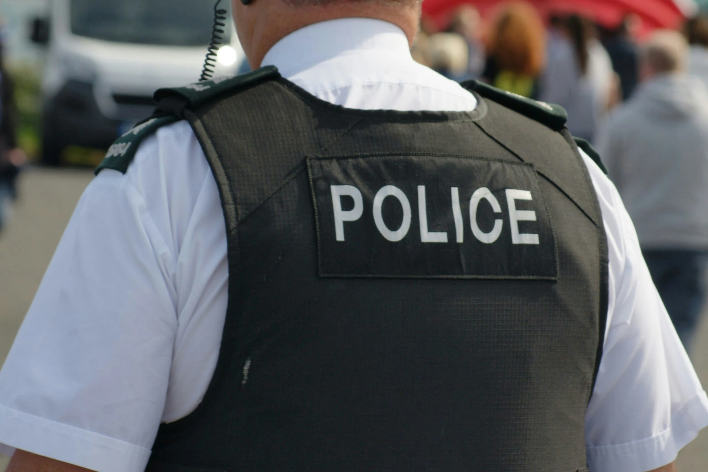 a police officer with a red umbrella in the background