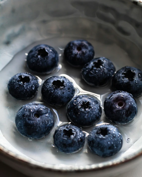 blueberries in a bowl with water over it