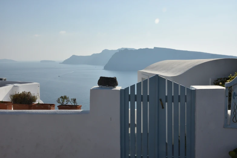 a view of the ocean and mountains from a balcony