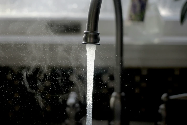 there is a stream of water flowing from a kitchen sink