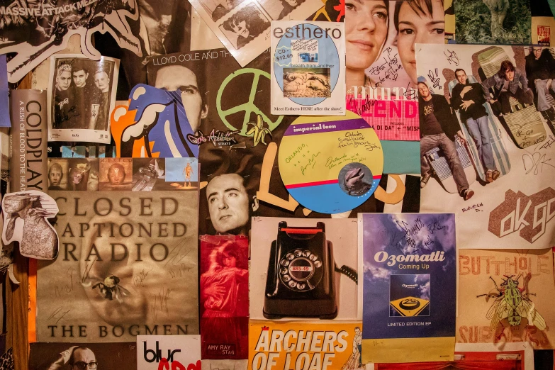 many colorful posters are arranged over a table