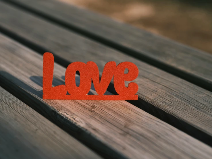 the word love has been made from small cut out pieces of wood