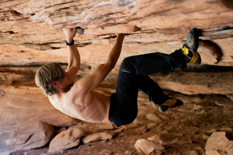 a man in  climbing on rocks