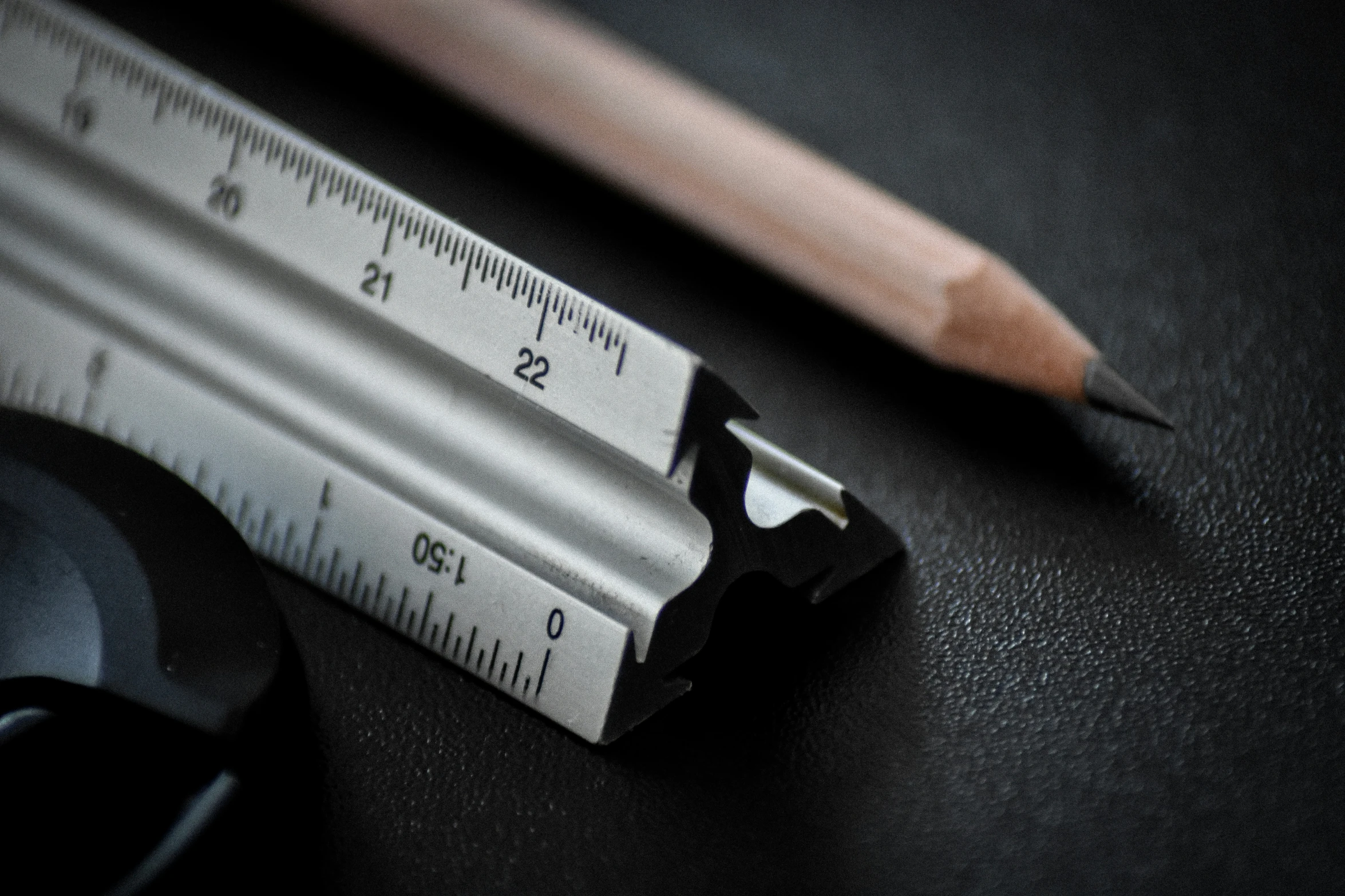 a pencil and a ruler laying on top of a table