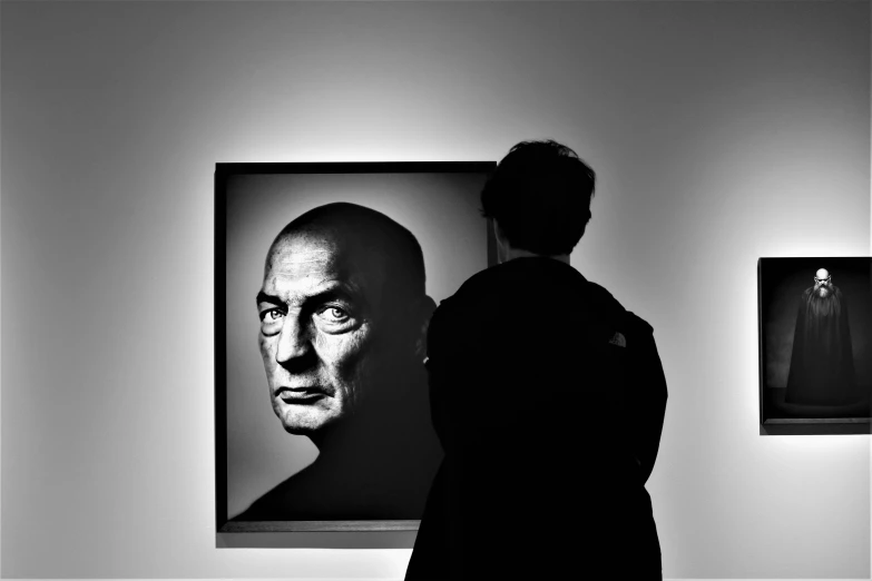 a woman standing in front of a painting