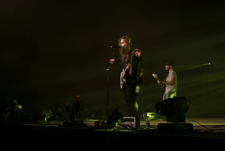 a band on stage at a concert during the night