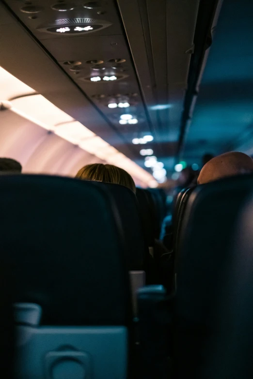 people sit on seats on an airplane