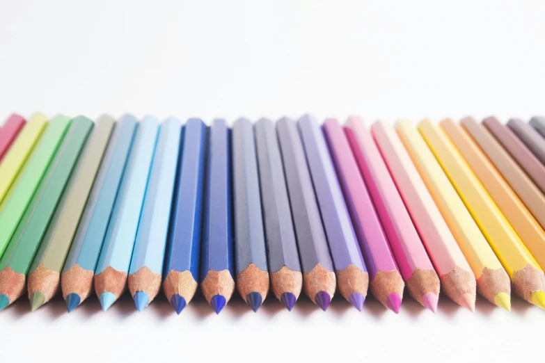 close up view of a row of colored pencils