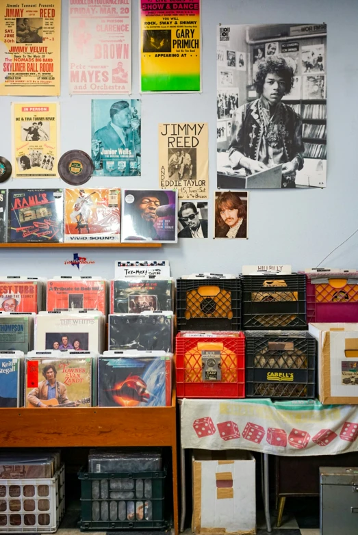 records are on the shelves, on which are various posters
