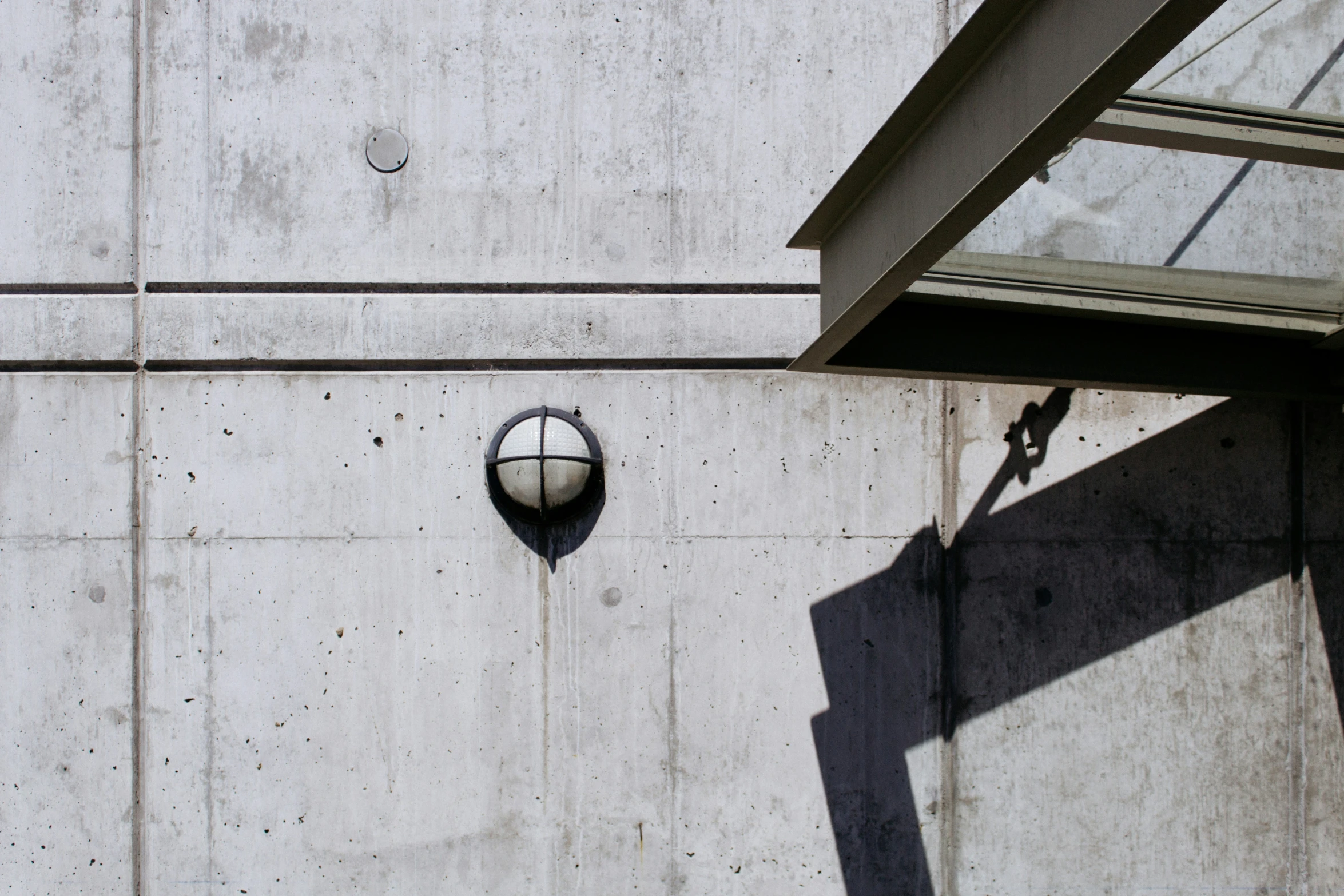 a clock on a wall next to a small window