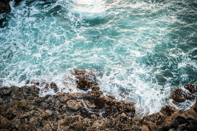 a large body of water next to a rocky shoreline