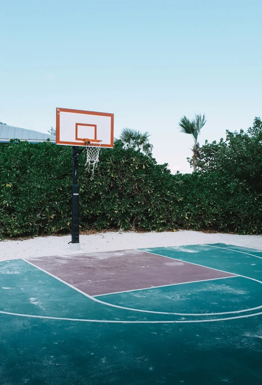 a basketball court with a fence and gate