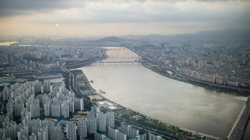 an aerial view of city skyline with river in the foreground