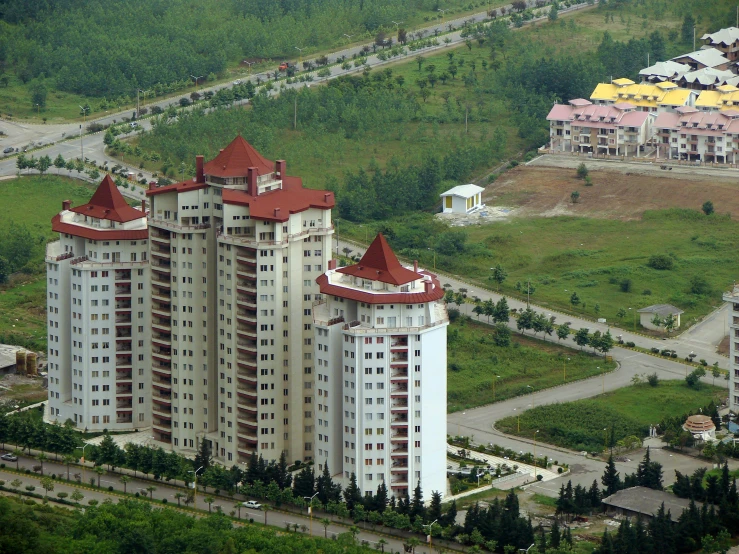 many tall buildings in an aerial view next to trees