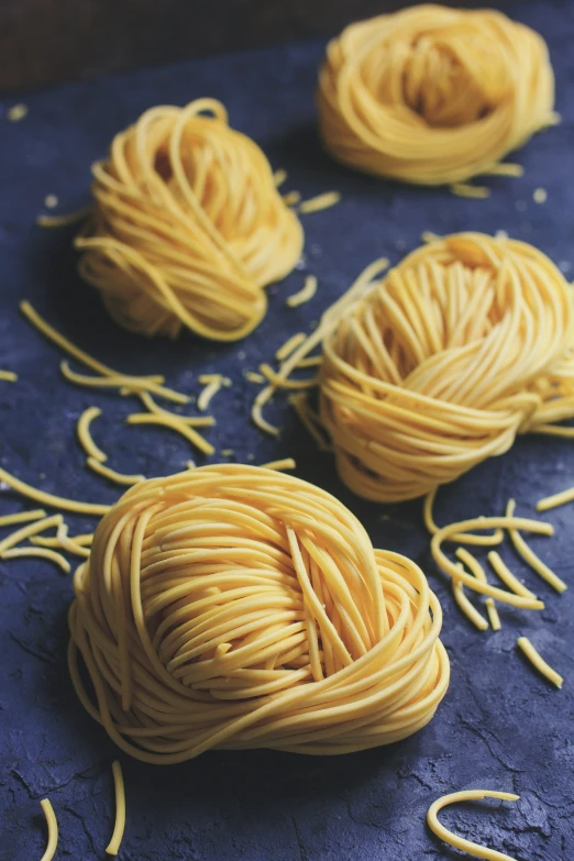 several balls of yellow yarn and yarn sticks on a table