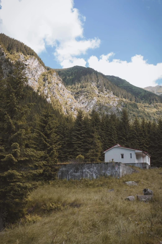 a barn on the side of the road near trees