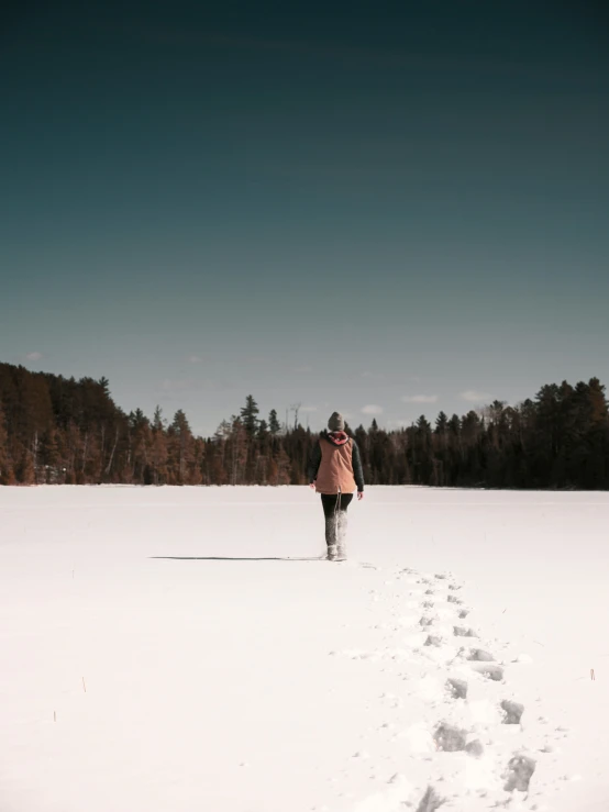 a person walking in the snow with one foot in the air