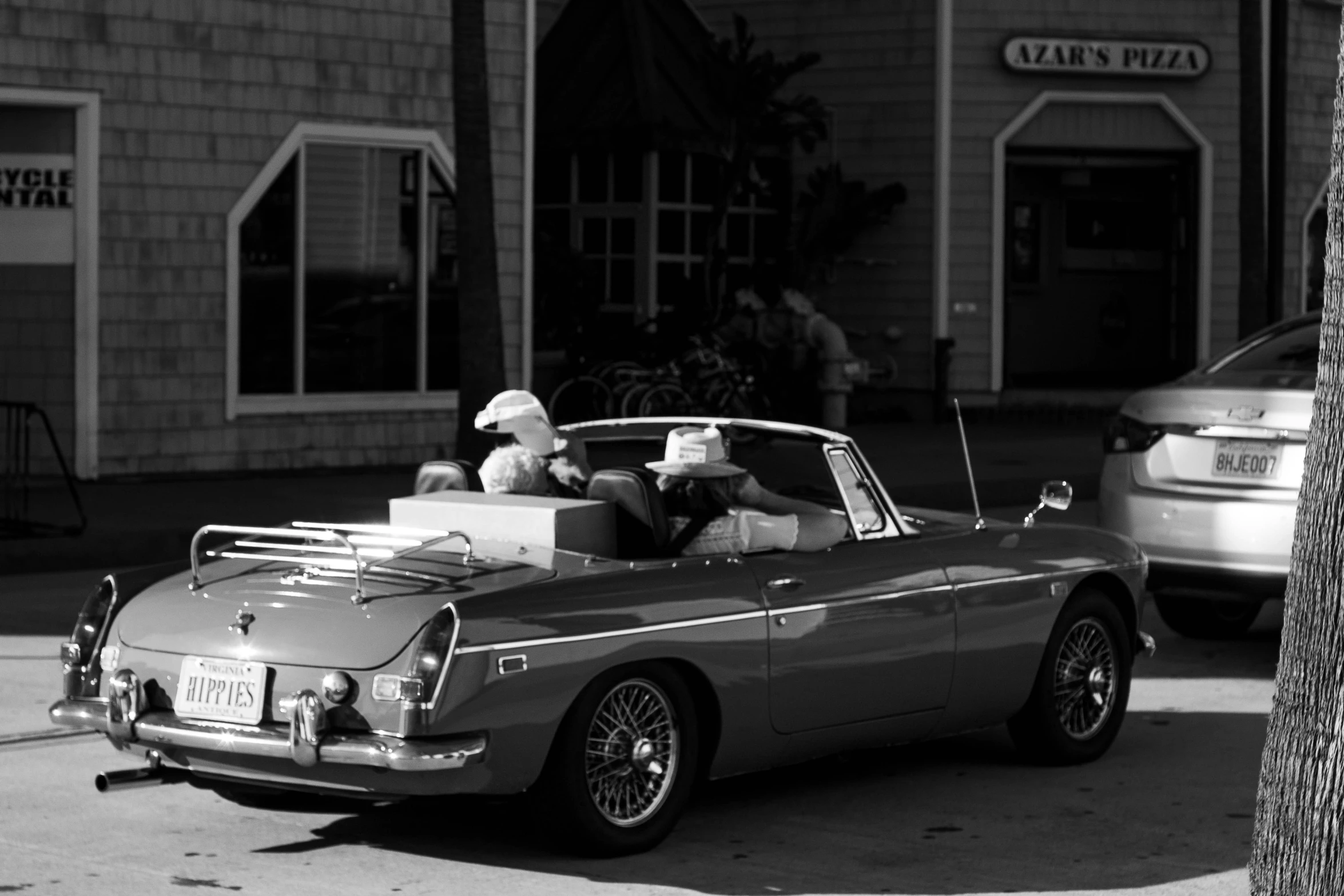 two people in the back of an old classic car