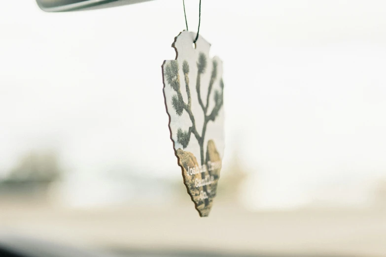 a wind chime hanging from the side of a street