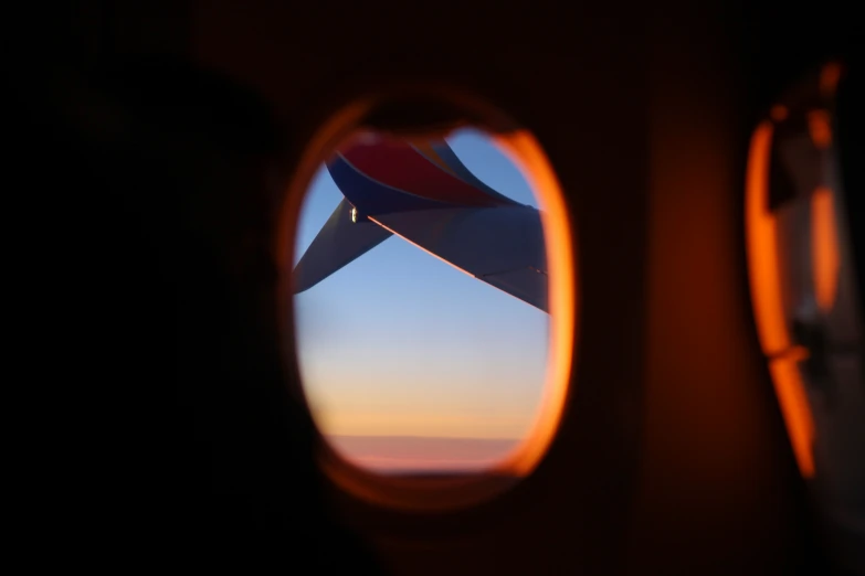 an airplane wing viewed from the window of an air plane