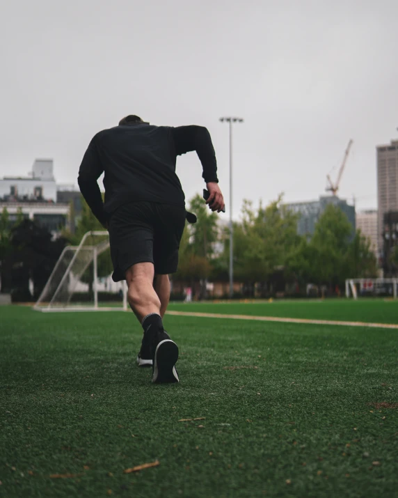 a man with a glove and a soccer ball on a field