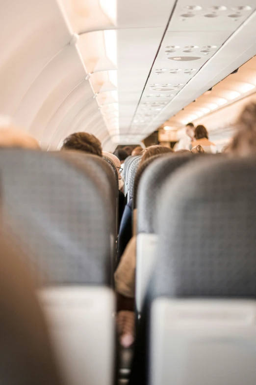 the inside of an airplane with a lot of people