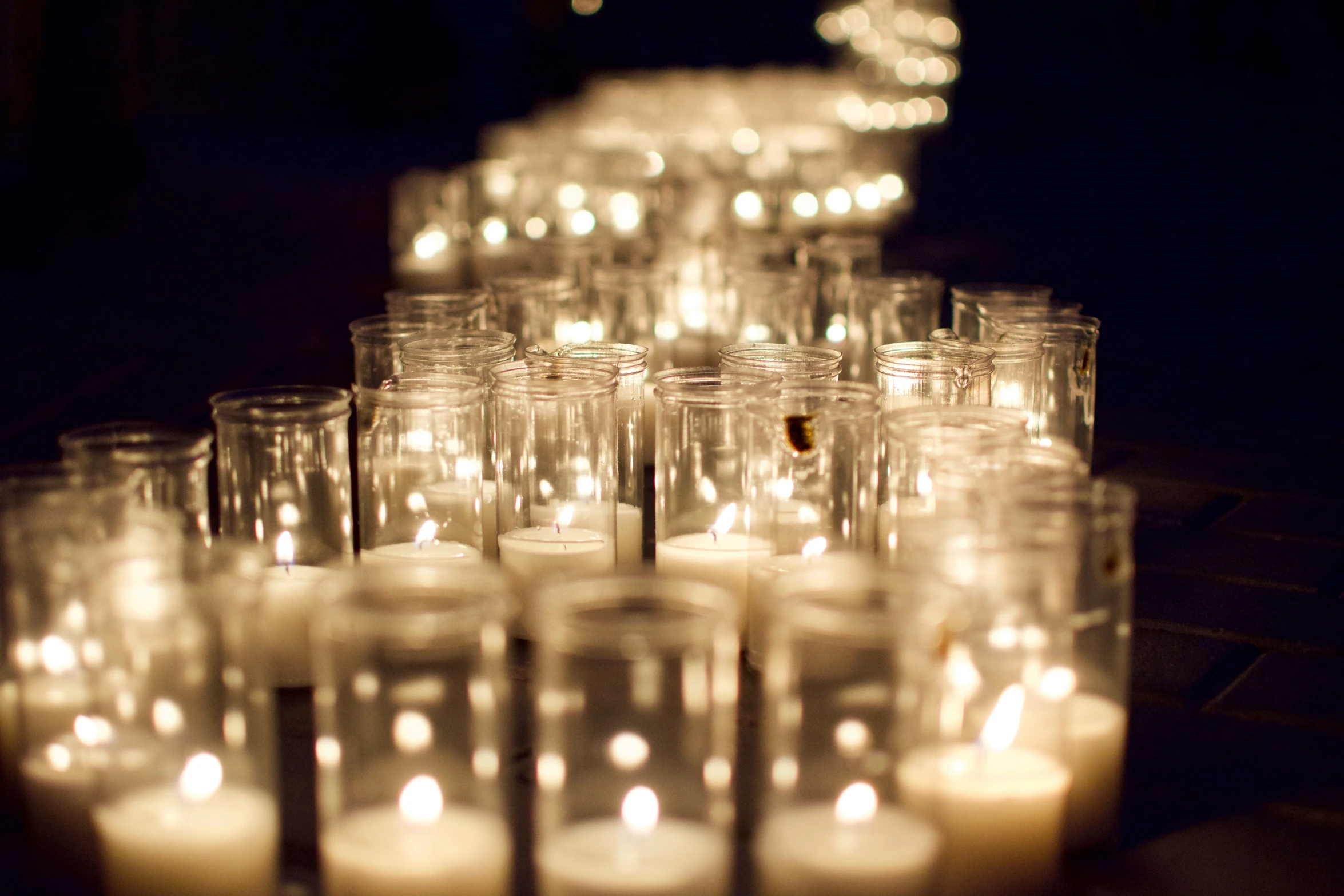 a bunch of lit candles sit on top of a table