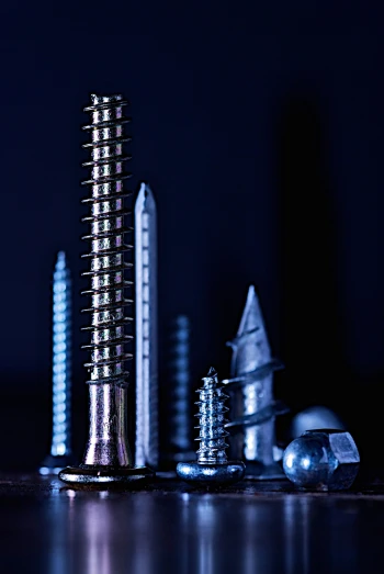 several small metal objects on a shiny surface