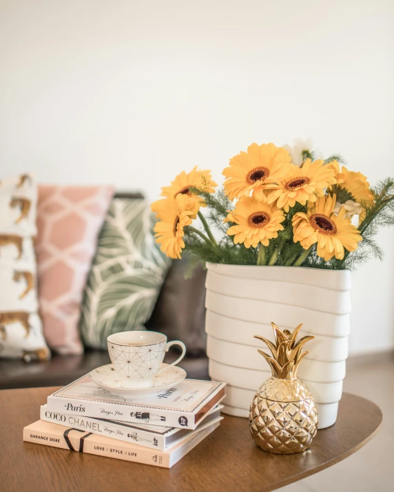 the coffee cup is sitting on a table next to several books