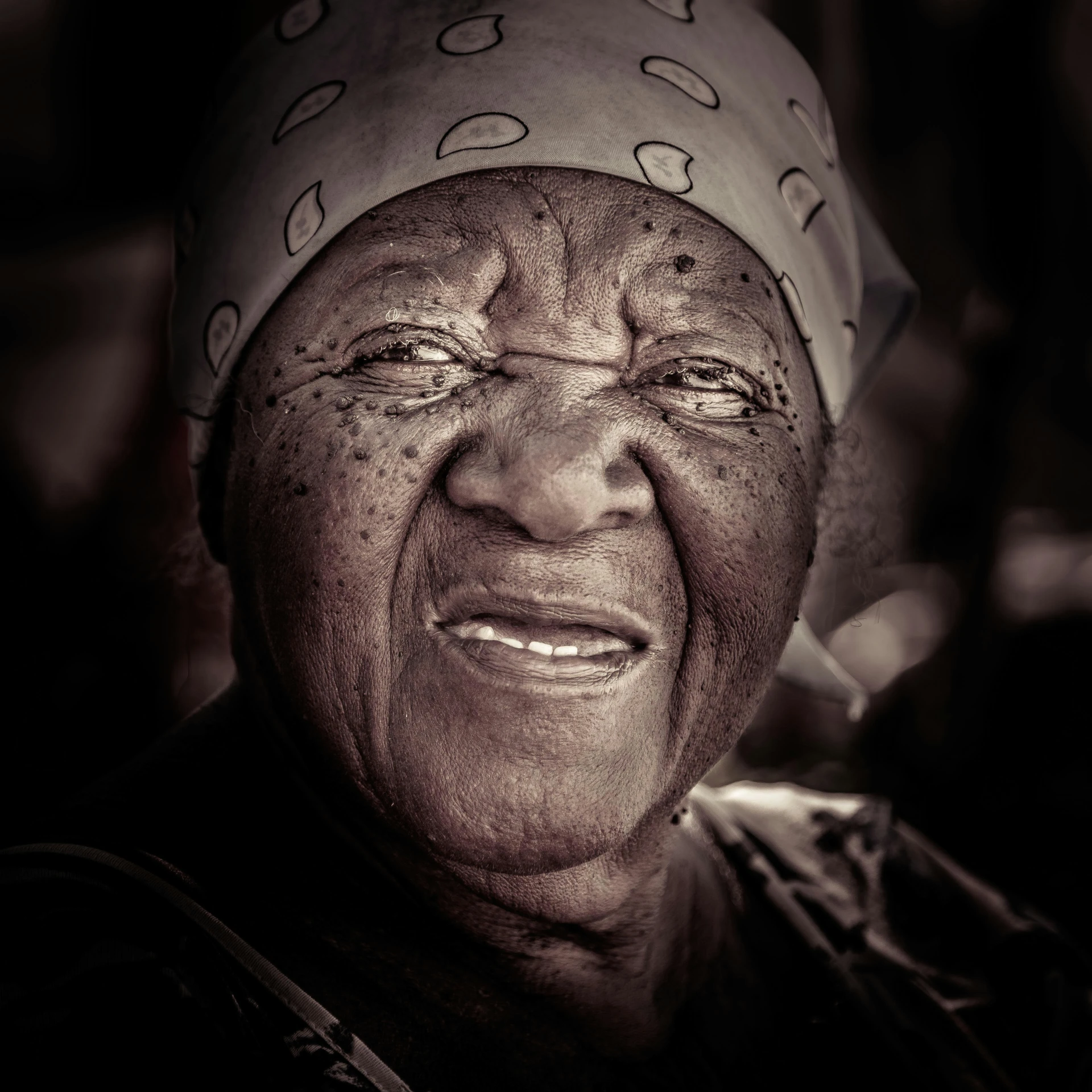 an elderly woman looking at the camera and smiling