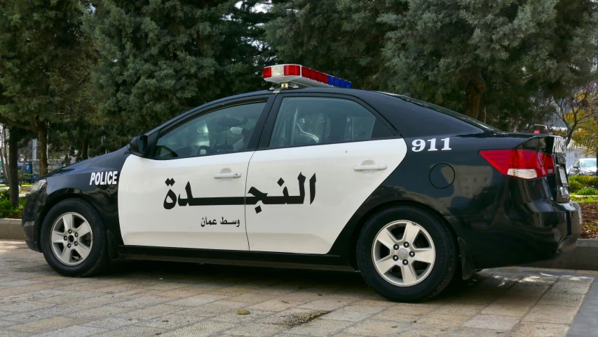 a car with writing on it parked on a city street