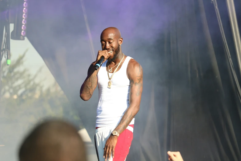 a man that is holding a microphone near a stage