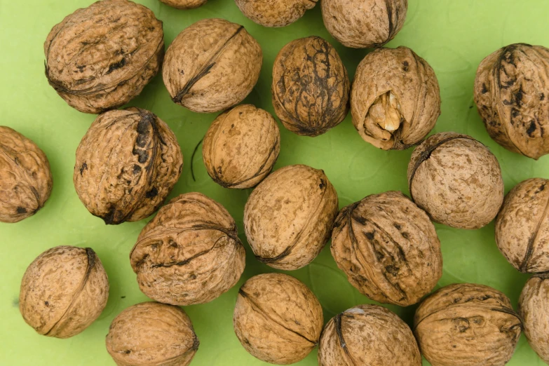 a group of nuts sitting on top of a green table