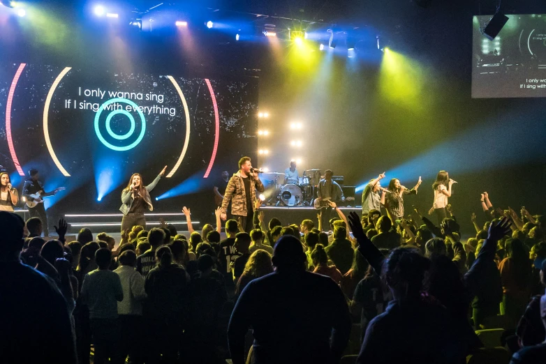 a concert with one man standing in front of the crowd