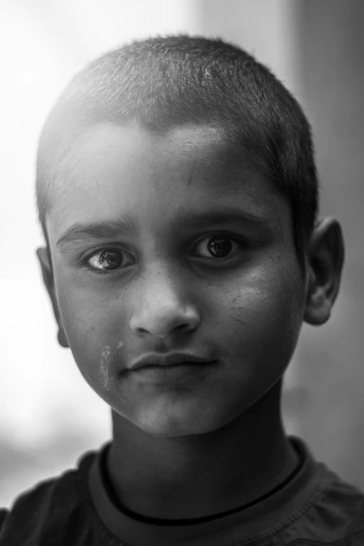 black and white pograph of boy looking into camera