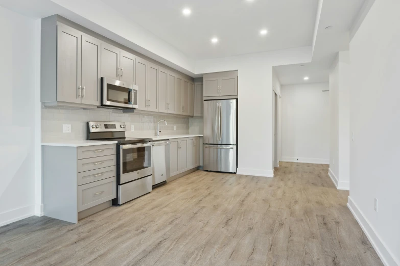 a large open kitchen with light colored cabinets