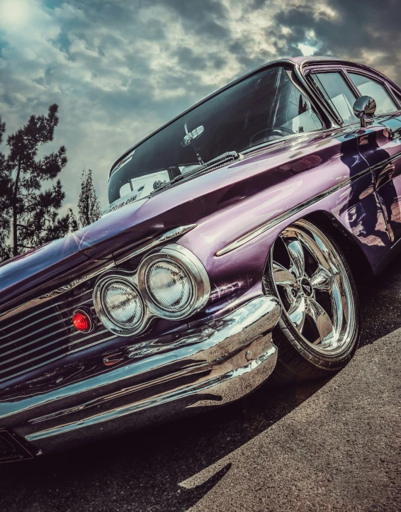 a purple classic car parked on the side of the street