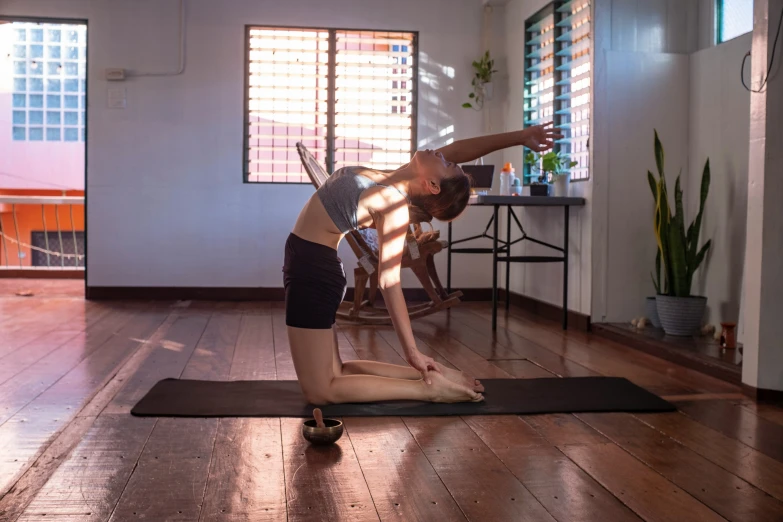 a woman practicing yoga inside her home studio