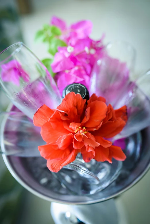 a vase with flowers inside it that is holding a coin