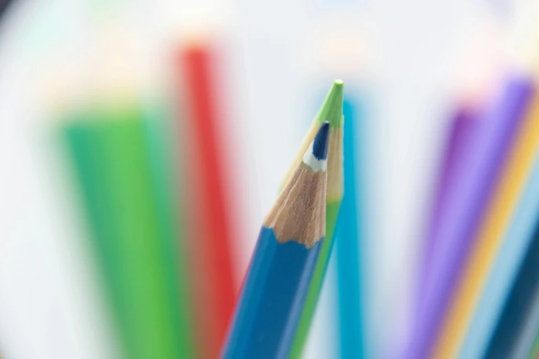 a pile of colored pencils sitting in the middle of each others