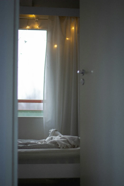 a bed sitting inside of a room under a window