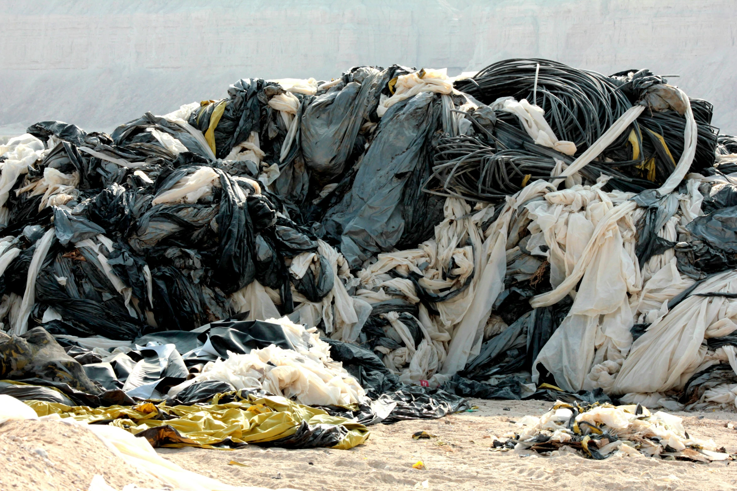 large piles of trash sitting in a desert