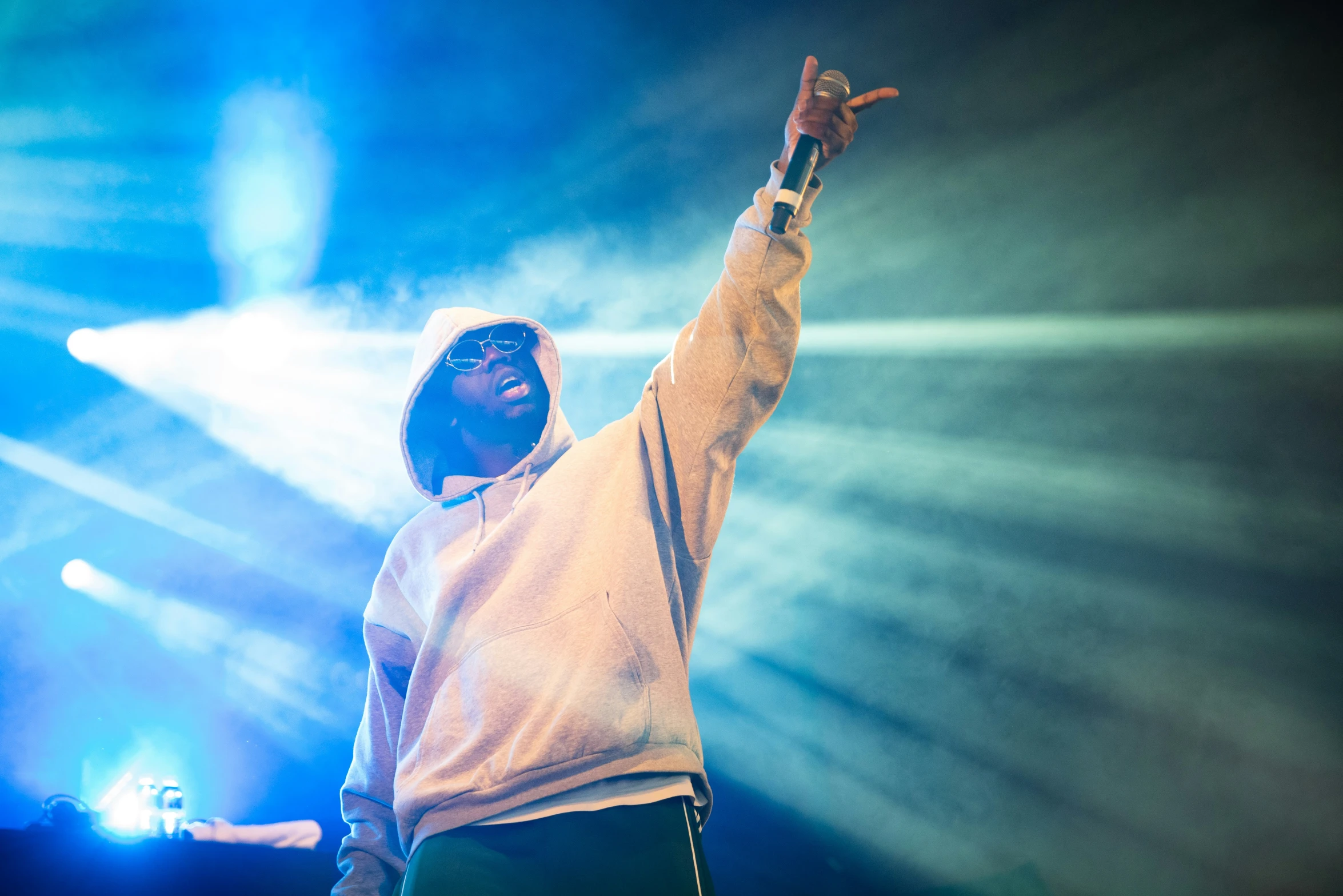 a man standing in front of a crowd holding his hands up