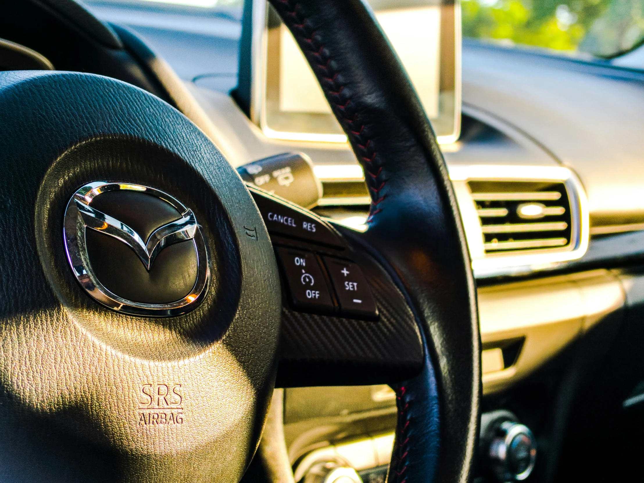 the inside view of a car with a clock in the center