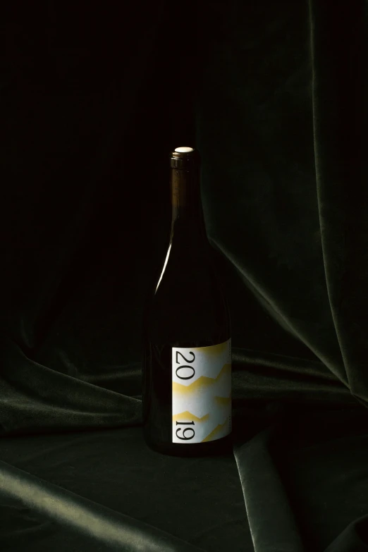 a bottle of wine on a black cloth